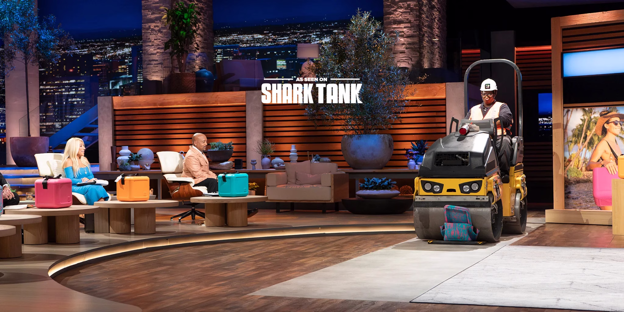 An industrial steamroller driving over a FOAM Cooler during the Shark Tank pitch