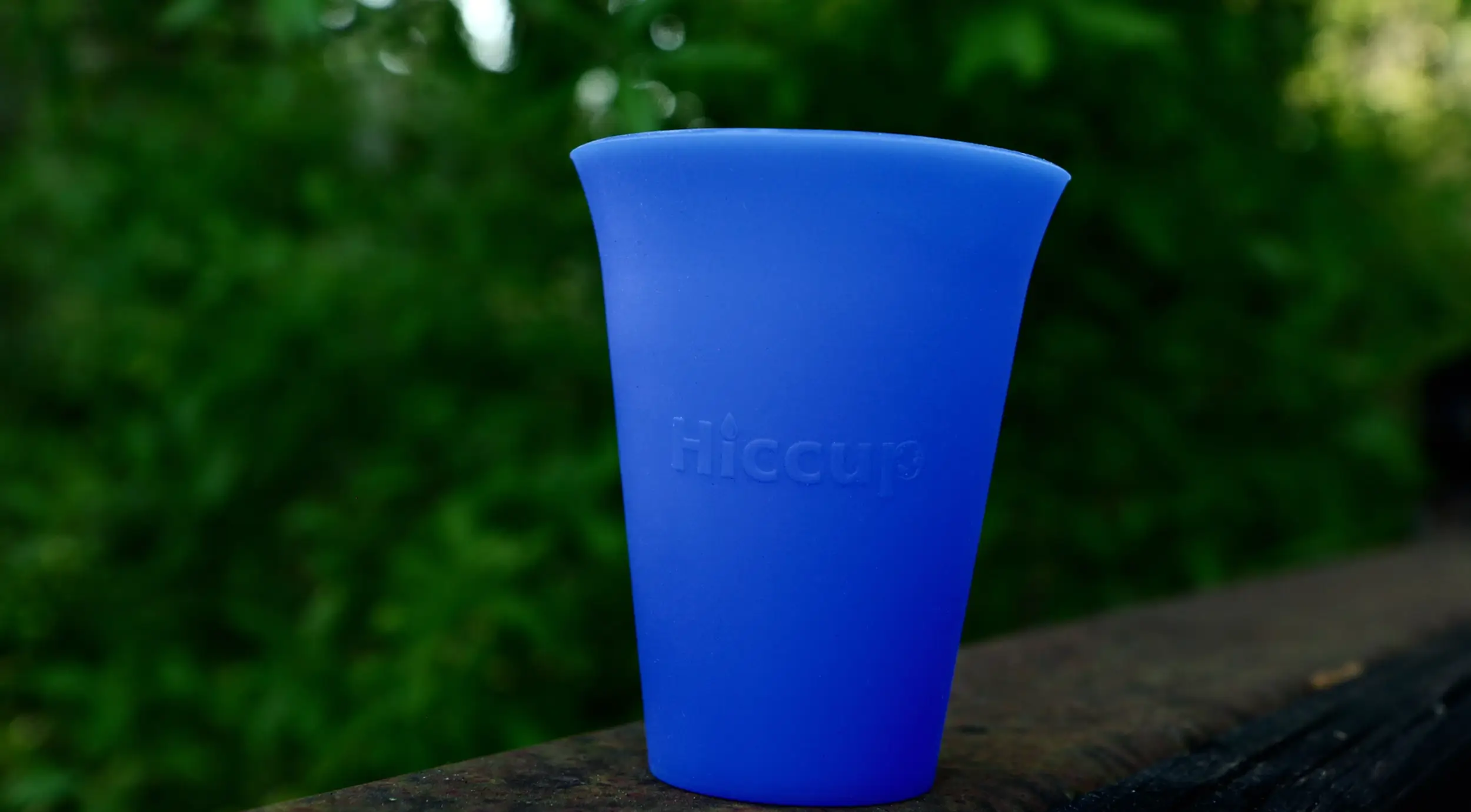 Runners using the reusable Hiccup cups at an endurance race hydration station
