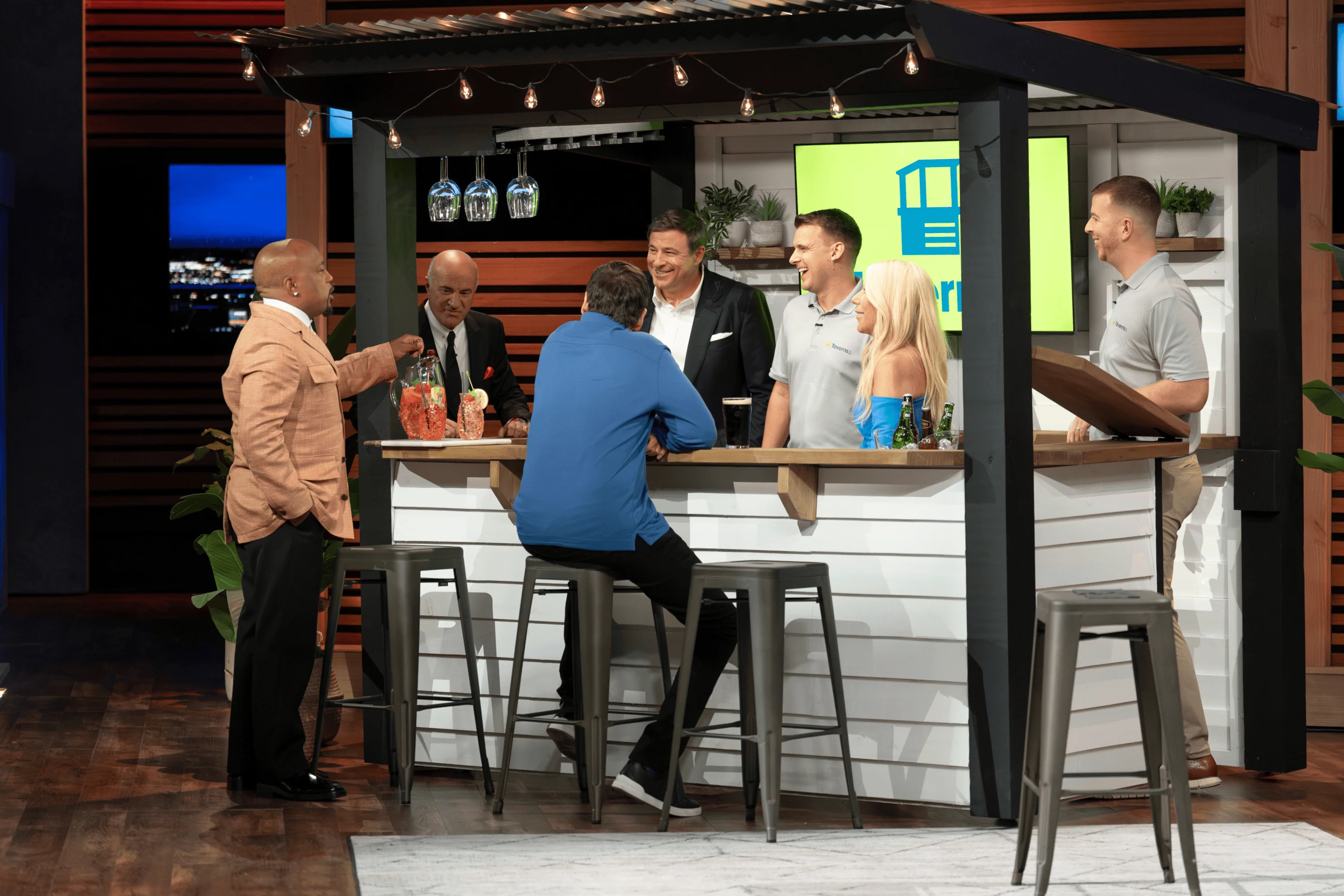 Paul Convey and Enda Crowley pouring beers behind their custom wooden bar in the Shark Tank