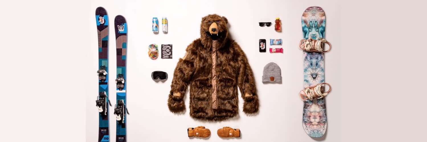 A group of skiers wearing various Wildcoat animal jackets on the mountain